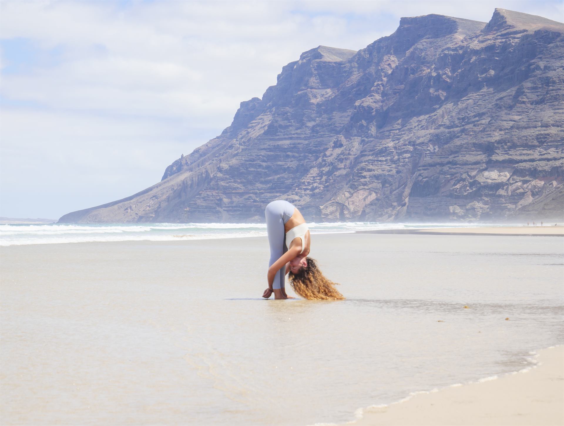 Seated forward fold by the sea